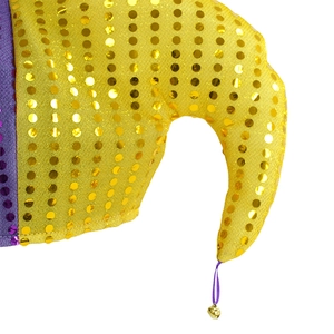 Macro shot of yellow clown hat with gold sequins, purple fabric and a small gold bell