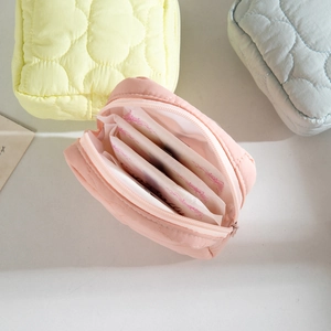 Quilted cloud cosmetic bag with interior dividers for sanitary pads and small items