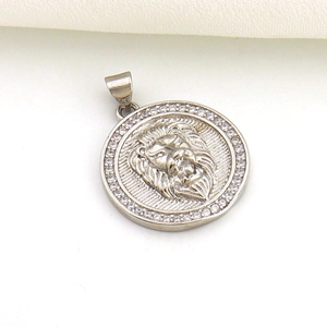 Close-up of a silver lion head pendant with micro-set clear zircons on white background