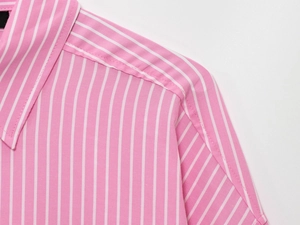 Close-up of pink and white striped shirt collar showing precise stitching and fabric texture