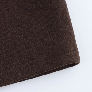 Close-up of deep brown wool blend fabric showing thick texture and soft fleece finish