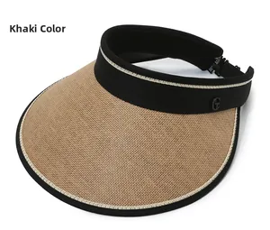 Detail view of khaki straw sun visor with black fabric trim and metal G buckle accent