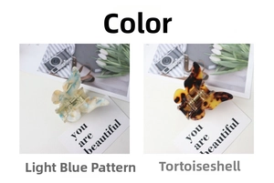 Detail of colorful acetate butterfly hair claws in blue marble and tortoise shell patterns