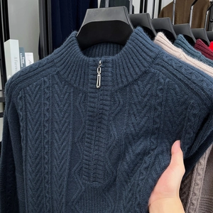 Detail view of navy blue half-zip cable knit sweater with textured fabric and collar
