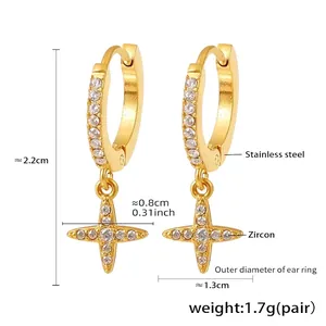 Detail view of gold stainless steel hoop earrings with zircon studded cross pendants