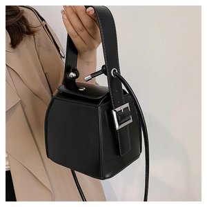 Close-up of black PU leather box bag featuring a silver square buckle and top handle
