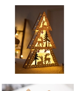 Detailed view of a wooden Christmas tree lamp featuring carved reindeer and warm LED bokeh