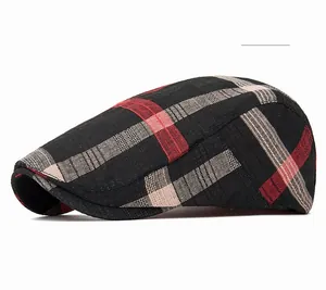 Detail of red and black plaid newsboy cap showing tweed fabric texture on white back