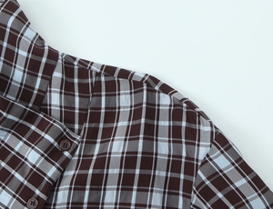 Detail shot of long sleeve plaid shirt collar and shoulder with high-quality fabric texture