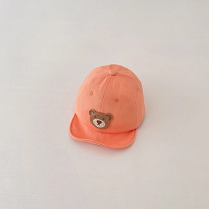 Detailed close-up of soft cotton orange baby baseball cap with cute bear embroidery