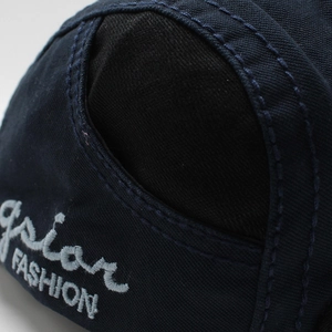 Macro detail of high-quality navy canvas beret featuring grey FASHION 3D embroidery