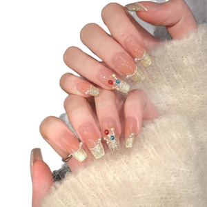 Nude long coffin press-on nails with champagne cat eye, glitter tips, and pearls