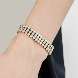 Detail of a luxury gold-plated men's bracelet with three rows of sparkling zircon stones