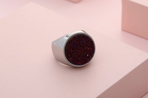 Macro view of a round purple druzy crystal set in a silver stainless steel signet ring