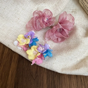 Detailed shot of handmade chiffon flower stud earrings with soft organza petals