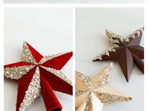 Detailed view of velvet and sequin Christmas tree toppers in red and gold finish