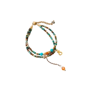 Bracelet bohème multicouche avec perles turquoise et breloque symbole féminin doré