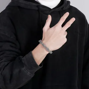 Detailed view of a vintage silver braided snake bone chain bracelet on a model's wrist