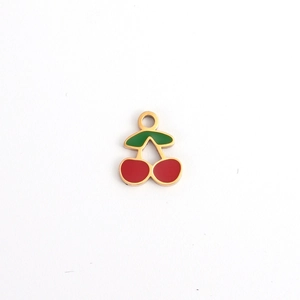 Detail of a cherry-shaped gold pendant with vibrant red and green enamel coating