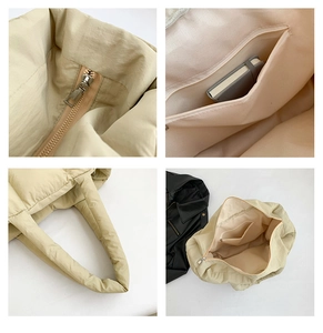Detail of cream puffy tote bag showing secure zipper closure and spacious interior pocket