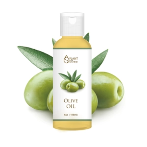 4oz bottle of pure olive oil with fresh green olives on a white studio background