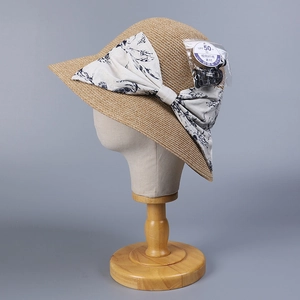 Elegant wide brim straw sun hat with large floral bow and UPF 50+ UV protection