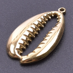Macro shot of a gold-plated shell pendant with a polished metallic finish on a dark background