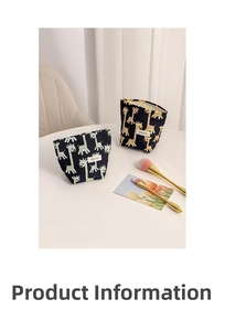 Close-up of giraffe pattern canvas makeup bags in navy and grey on a white table