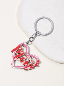 Detailed view of red heart MAMA keychain with I Love You engraving on stone background