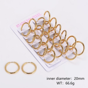 Detailed view of 12 pairs of 20mm gold stainless steel hoop earrings on a display card