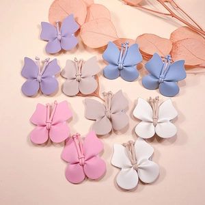 Platte weergave van kleurrijke PU-lederen vlinderhaarklemmen in roze, paars, blauw en beige