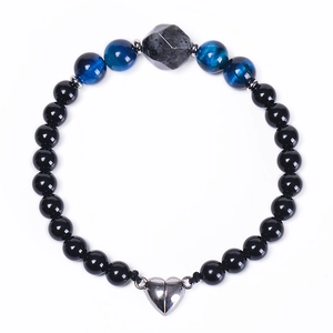 Detail of beaded bracelet with black stones and heart-shaped magnetic clasp