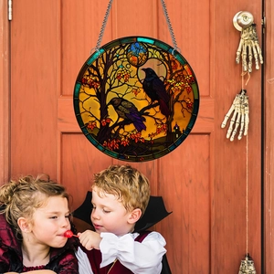 Detail of round Halloween acrylic crow ornament hanging on a wooden door with chains