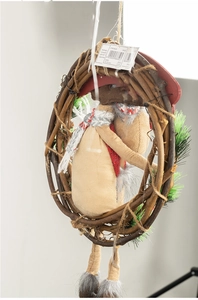 Detail of Christmas wreath with plush reindeer figure and striped scarf on twig ring