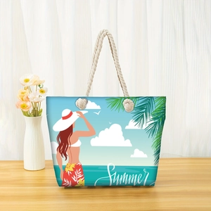 Detail of summer beach tote bag with thick rope handles and coastal illustration