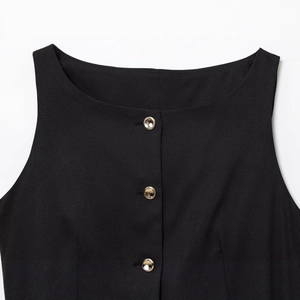 Women's black sleeveless top with round neck and three golden cylindrical metal buttons