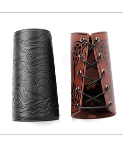Detail view of viking leather bracers with embossed wolf and celtic knot patterns