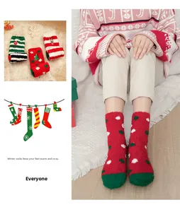 Detail of soft coral fleece Christmas socks featuring red and green festive patterns