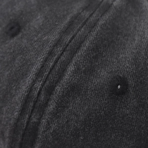 Close-up of washed gray baseball cap featuring reinforced eyelet and double stitching