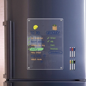 Clear acrylic dry erase weekly calendar for fridge with six colored markers on stainless steel