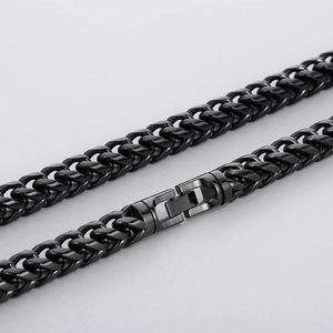 Gros plan d'un collier à maillons cubains noirs en acier inoxydable avec fermoir boîte