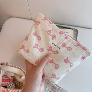 Pink bow and blue polka dot fabric makeup bag with 'Simple Wish' label detail