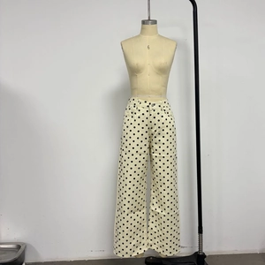 Detail showing white polka dot pattern on casual wide-leg denim trousers for women