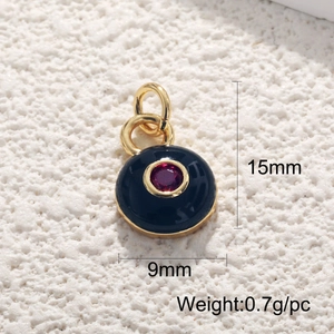 Macro view of 18K gold plated evil eye pendant with black enamel and red gemstone