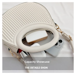 Top view of pleated crossbody bag showing interior storage for phone and cosmetics