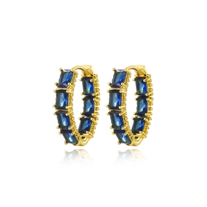 Detail of square blue zircon earrings with gold plating and reflective finish