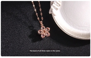 Detailed macro view of the rose gold clover pendant back and zircon setting details