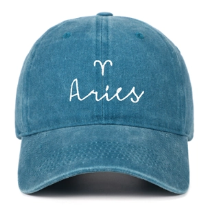 Close-up of Aries zodiac embroidery on vintage washed blue cotton baseball cap