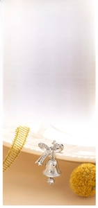 Detail of silver Christmas tree and bell studs with zircon bows on silk and ribbon