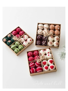 Detail of wool felt Christmas ball ornaments with festive patterns in kraft paper gift boxes